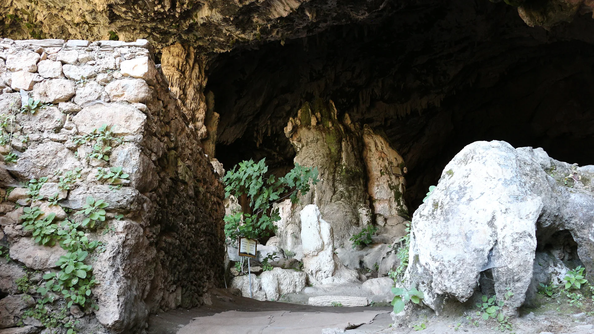 Rock formations and stone walls in the Agia Sofia Cave.